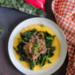 Top view of Instant Pot pulled pork with simmered collard greens and grits